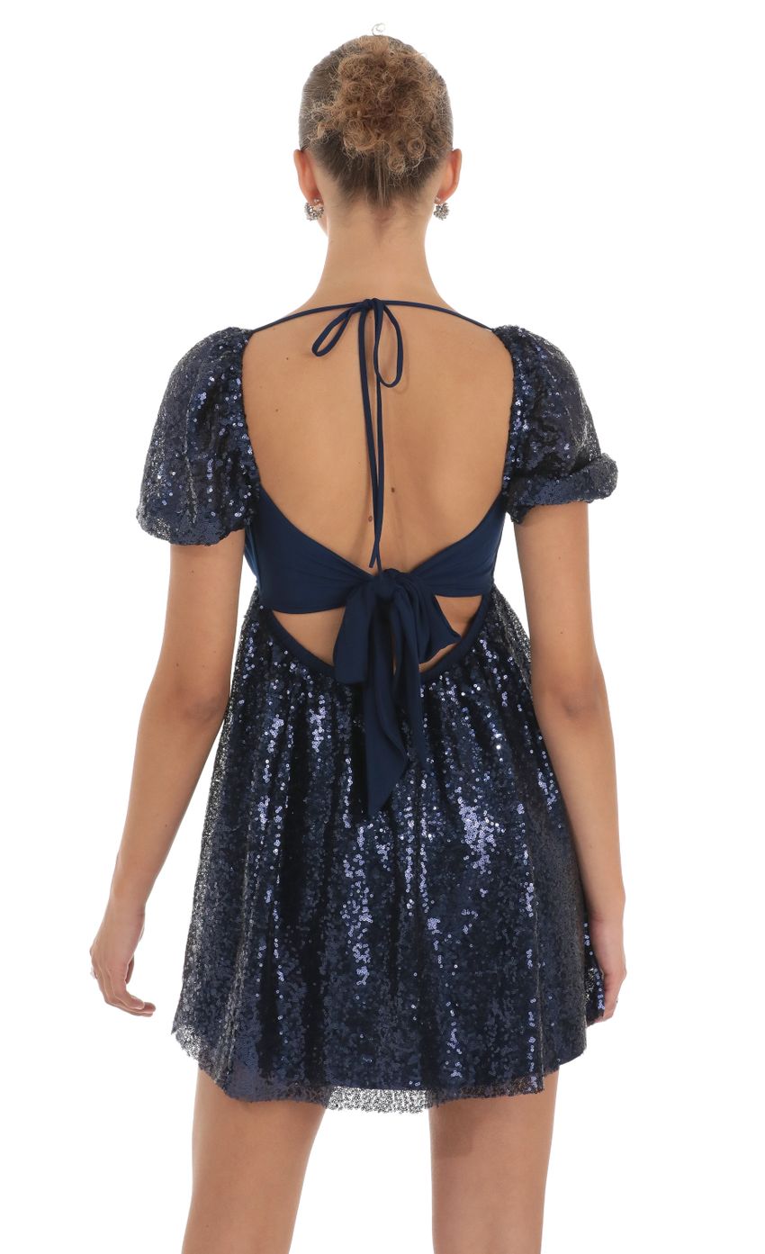 Picture Hana Sequin Puff Sleeve Baby Doll Dress in Navy. Source: https://media.lucyinthesky.com/data/Apr23/850xAUTO/ae54277f-a22e-4f38-8eda-d05a165cd9bb.jpg