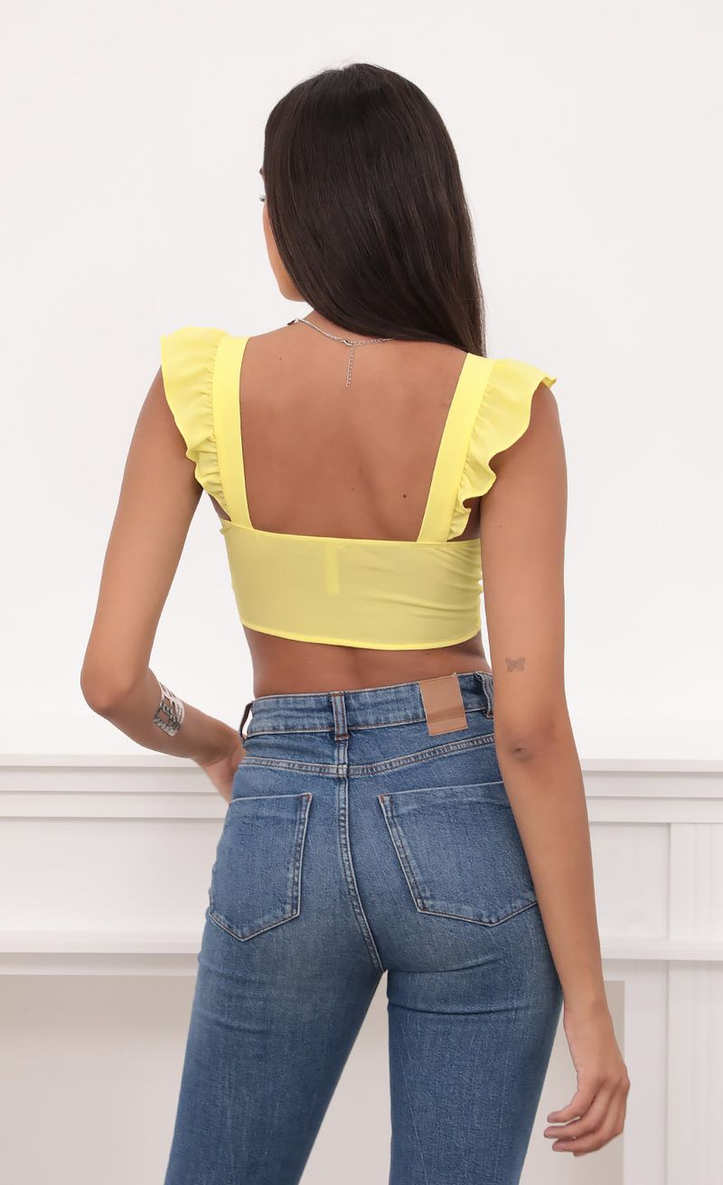 Picture Carolina Ruffle Tie Crop Top in Yellow. Source: https://media.lucyinthesky.com/data/Aug20_1/800xAUTO/781A9182.JPG