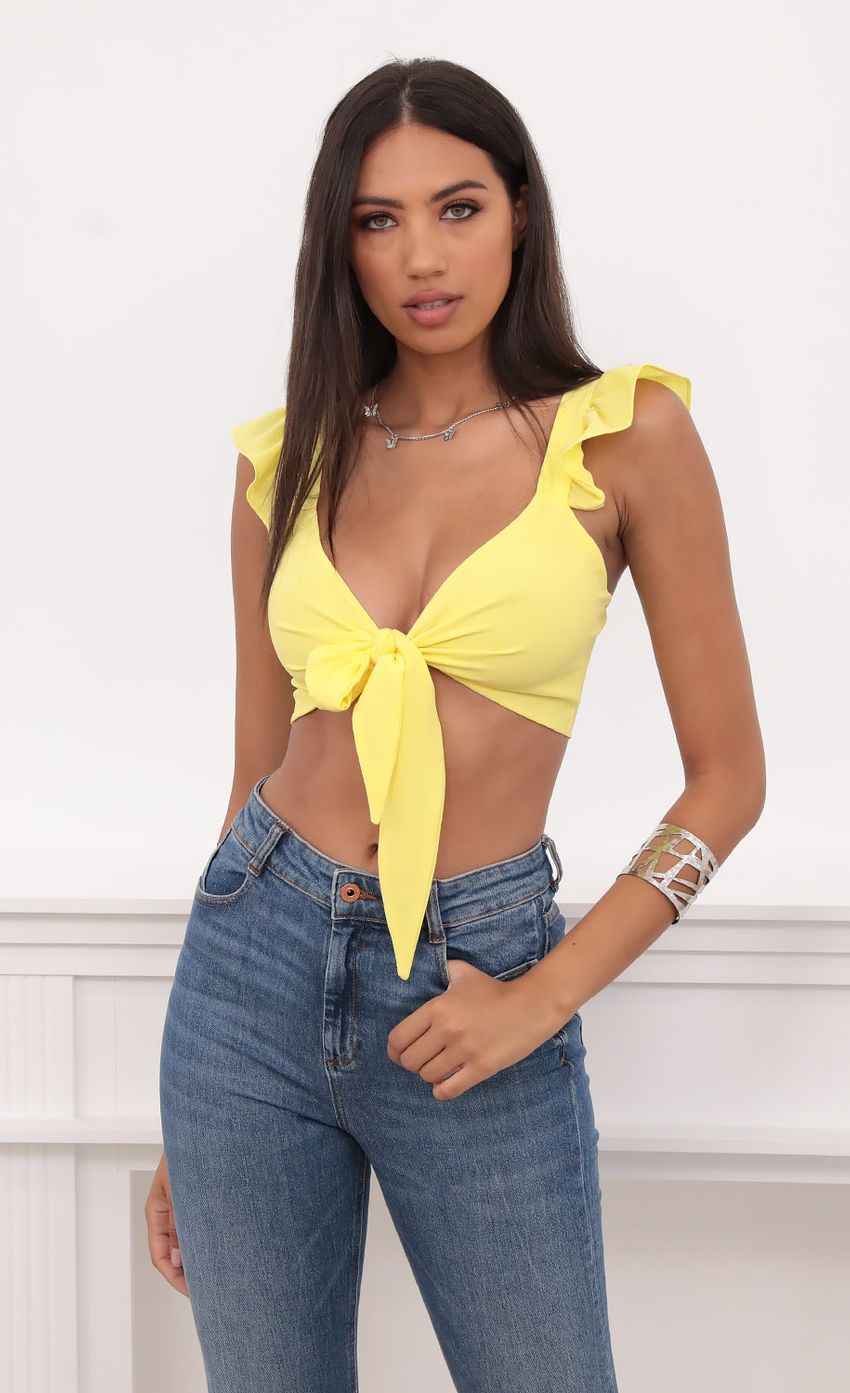 Picture Carolina Ruffle Tie Crop Top in Yellow. Source: https://media.lucyinthesky.com/data/Aug20_1/850xAUTO/781A9090.JPG