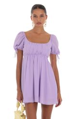 Picture Leilani Printed Chiffon Baby Doll Dress in White and Purple. Source: https://media.lucyinthesky.com/data/Aug23/150xAUTO/9774c50d-cadf-49c2-a7f2-7b2f96b64aa2.jpg