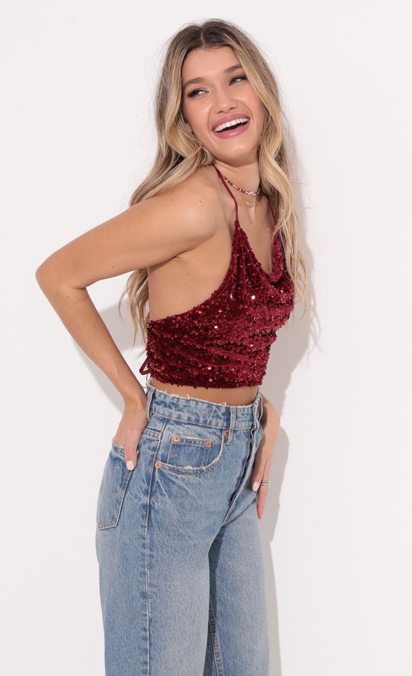 Picture Tali Iridescent Sequin Halter Top in Red. Source: https://media.lucyinthesky.com/data/Dec21_1/850xAUTO/1V9A4839.JPG