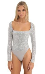 Picture Aislin Sequin Long Sleeve Bodysuit in Silver. Source: https://media.lucyinthesky.com/data/Dec22/150xAUTO/2235d5b6-b59a-4fa2-ab11-499b110f53f3.jpg