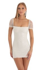 Picture Clarita Glitter Short Sleeve Bodycon Dress in White. Source: https://media.lucyinthesky.com/data/Dec22/150xAUTO/e65d94f9-25d2-4c24-96d4-90da39ab86ae.jpg