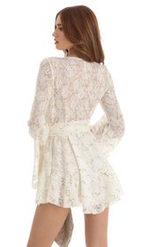 Picture thumb Raquella Sequin Lace Wrap Dress in White. Source: https://media.lucyinthesky.com/data/Dec22/170xAUTO/dae8c9a6-3deb-4af3-9964-747c719356d0.jpg