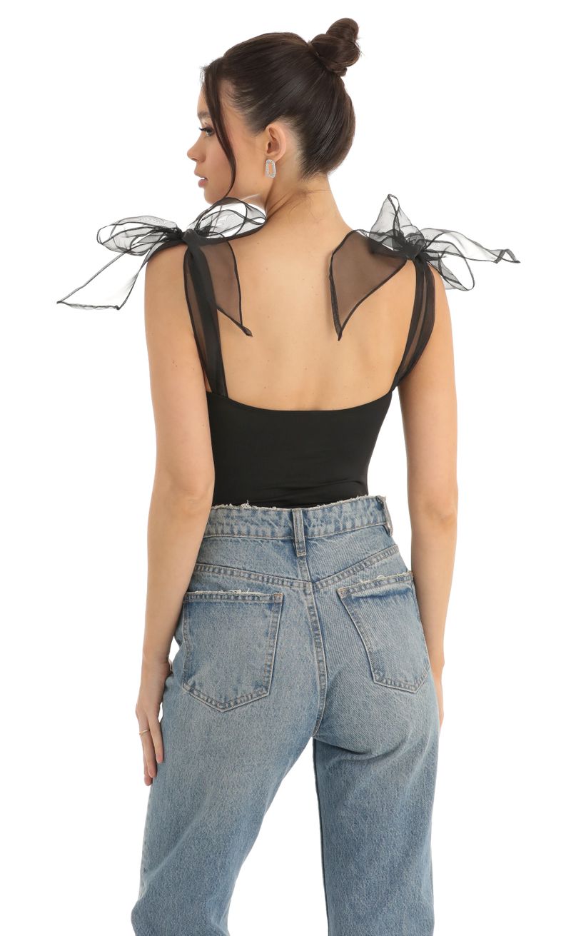 Picture Traci Bow Bodysuit in Black. Source: https://media.lucyinthesky.com/data/Dec22/800xAUTO/c767b260-f1b7-4905-af46-49e3ee172109.jpg