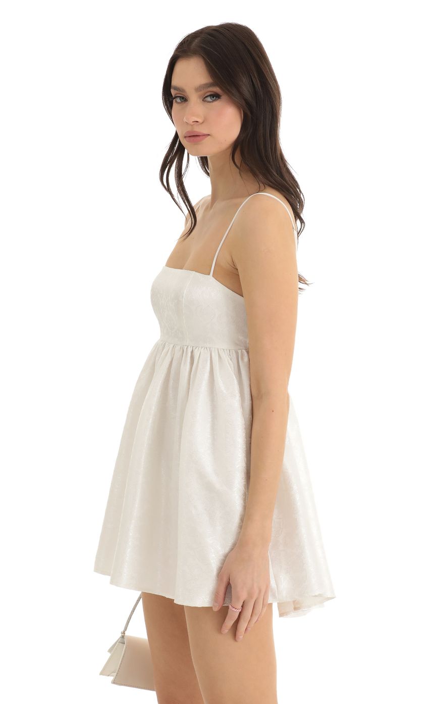 Picture Liora Floral Jacquard Baby Doll Dress in White. Source: https://media.lucyinthesky.com/data/Dec22/850xAUTO/73185c56-1871-494b-b0f1-2b591e088a3a.jpg