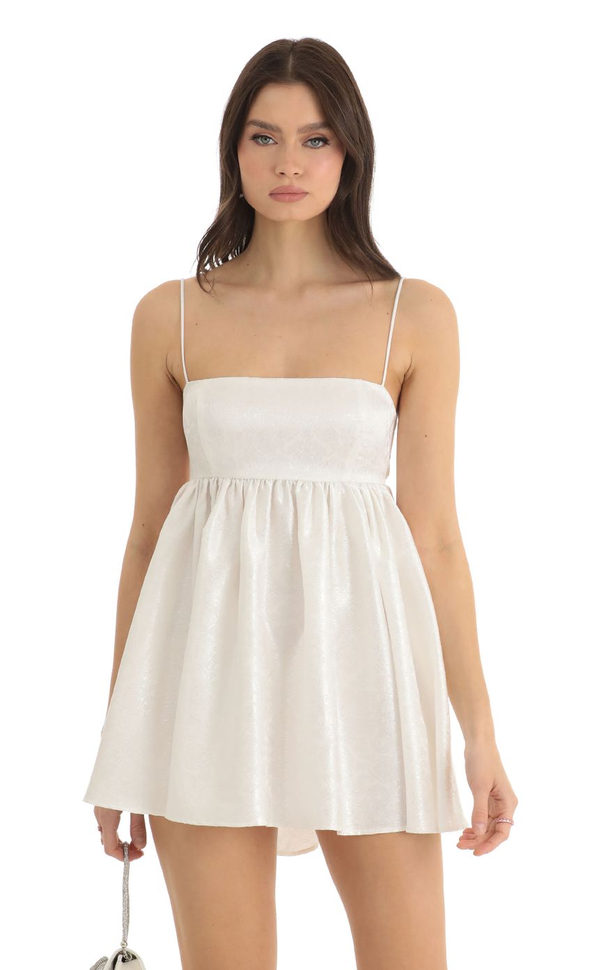 Picture Liora Floral Jacquard Baby Doll Dress in White. Source: https://media.lucyinthesky.com/data/Dec22/850xAUTO/c63ccce1-740f-41a9-a3ae-ef447f7b1566.jpg