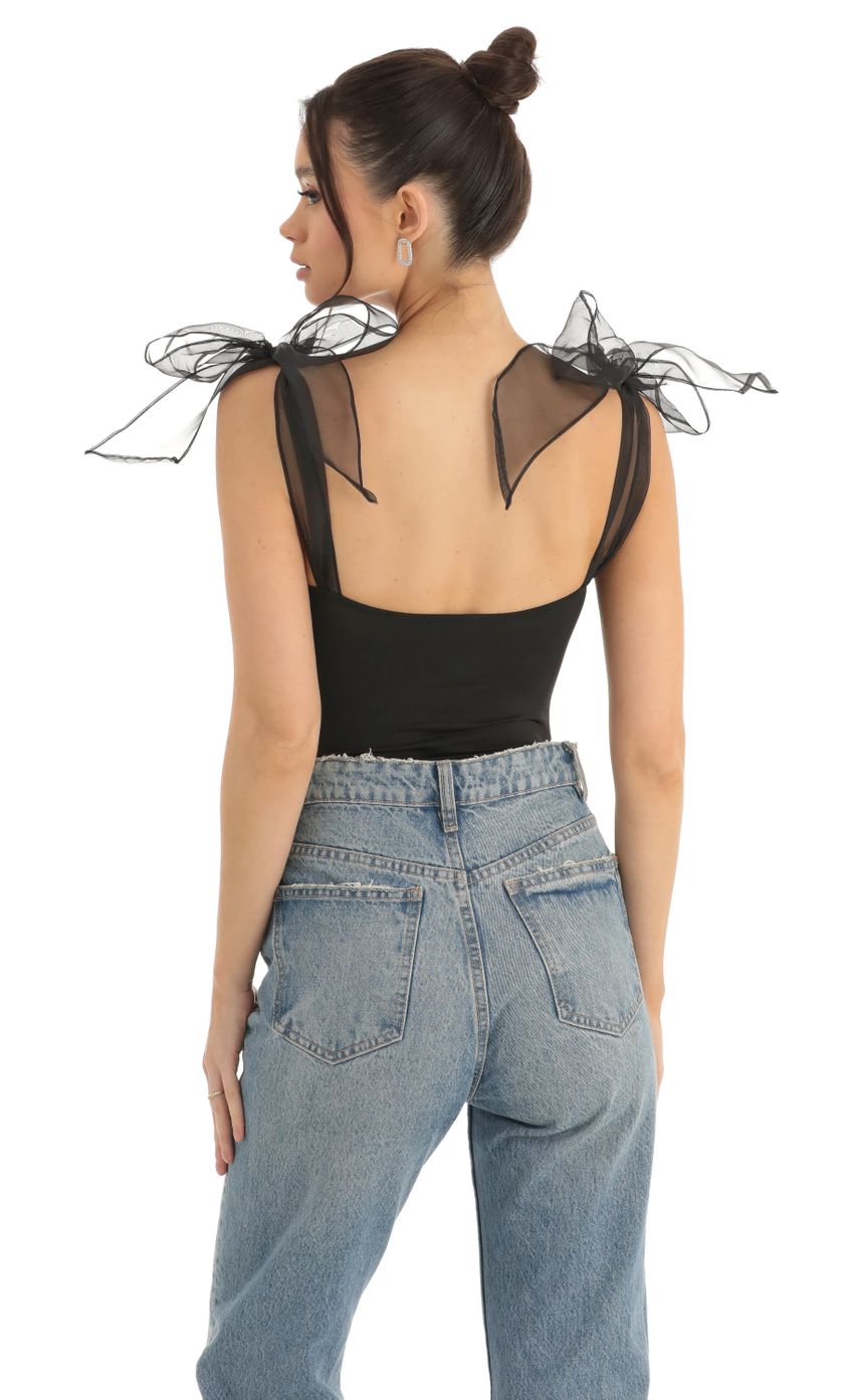 Picture Traci Bow Bodysuit in Black. Source: https://media.lucyinthesky.com/data/Dec22/850xAUTO/c767b260-f1b7-4905-af46-49e3ee172109.jpg