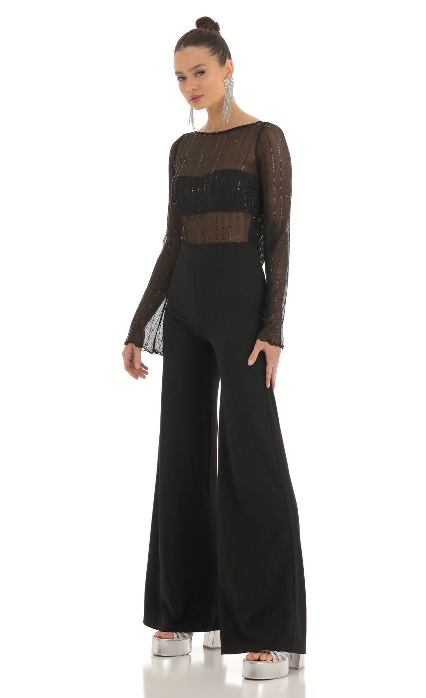 Picture Olean Sequin Striped Long Sleeve Jumpsuit in Black. Source: https://media.lucyinthesky.com/data/Feb23/850xAUTO/2fcb3966-1453-423e-b2af-fd3fe269845b.jpg
