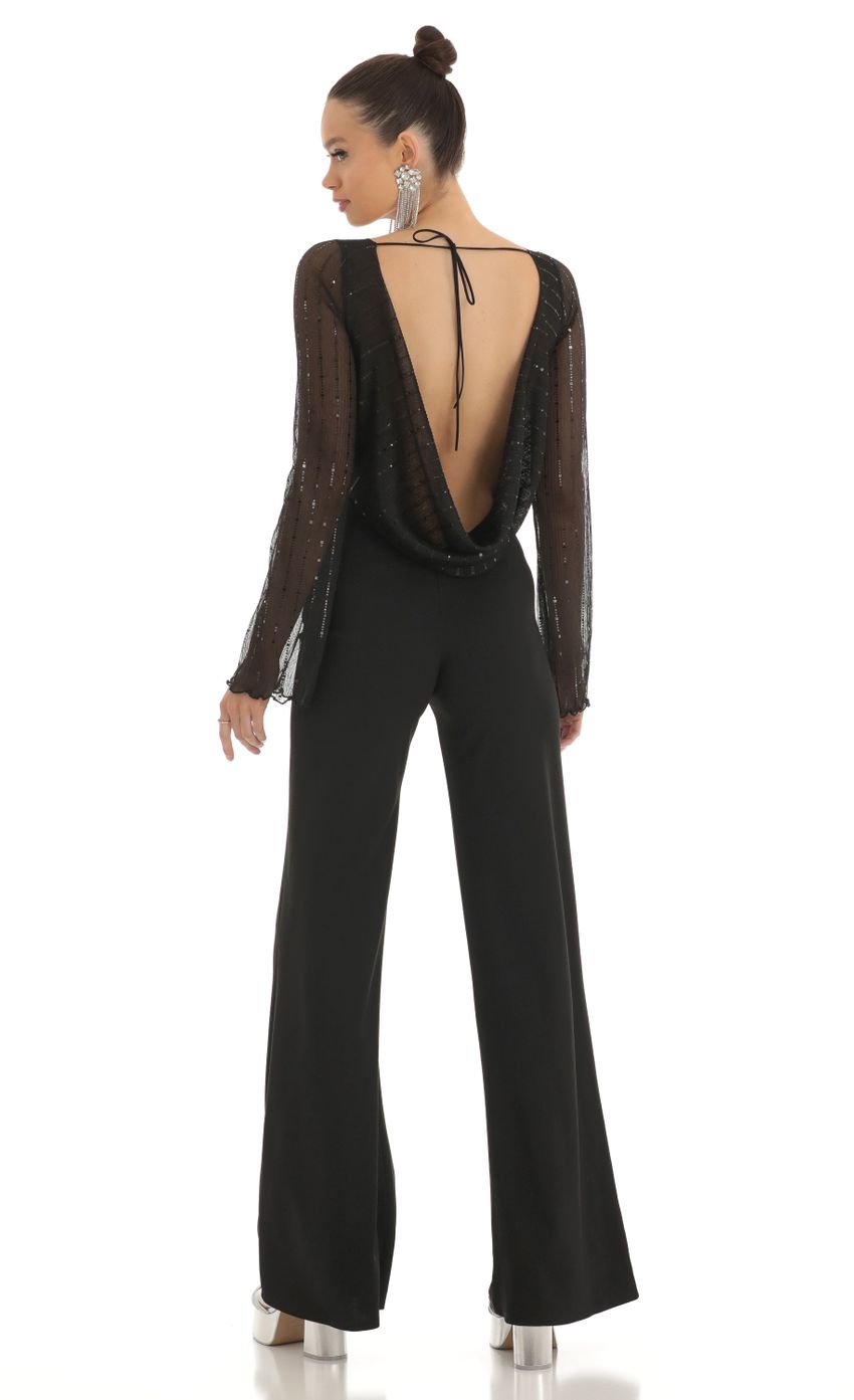Picture Olean Sequin Striped Long Sleeve Jumpsuit in Black. Source: https://media.lucyinthesky.com/data/Feb23/850xAUTO/74212d42-5153-450e-81cf-736bb4fd89d0.jpg