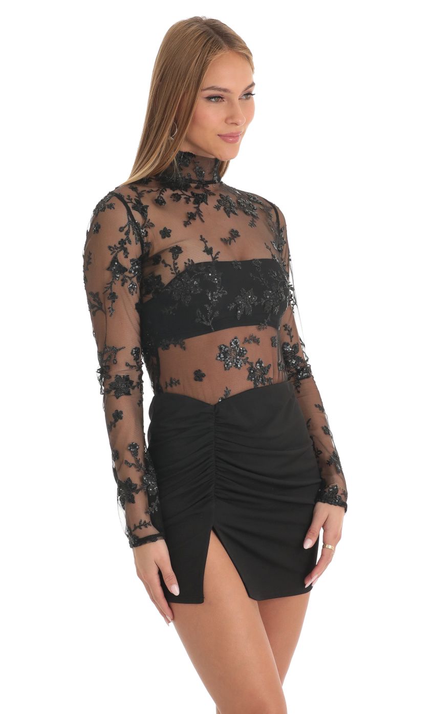 Picture Helia Tulle Glitter Sheer Mock Neck Dress in Black. Source: https://media.lucyinthesky.com/data/Feb23/850xAUTO/e95f482f-3c5c-4933-991c-5d9137cec2bf.jpg