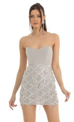 Picture Hollie Dangling Sequin Corset Dress in White. Source: https://media.lucyinthesky.com/data/Jan23/150xAUTO/4ba74848-8870-4e29-a26a-b662715ce715.jpg
