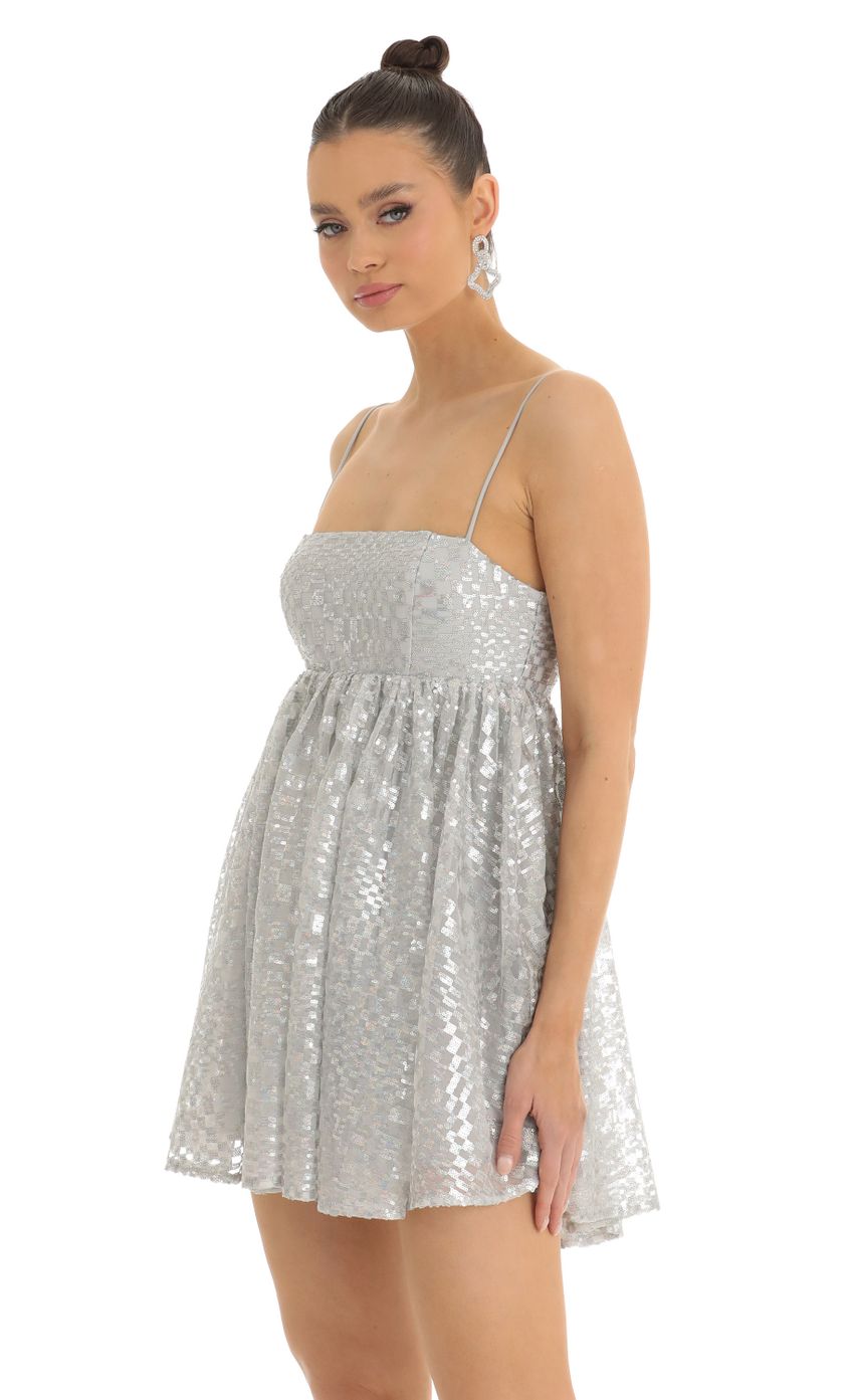 Picture Liora Checkered Sequin Baby Doll Dress in Silver. Source: https://media.lucyinthesky.com/data/Jan23/850xAUTO/00e1e270-b5b5-47b6-a6cb-1d3caf2d46d2.jpg
