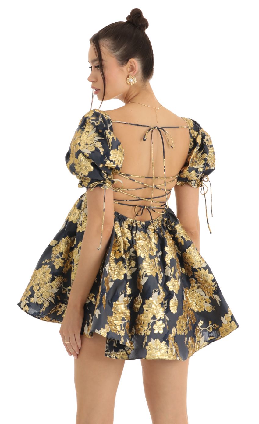 Picture Cheri Gold Floral Jacquard Baby Dolly Dress in Navy. Source: https://media.lucyinthesky.com/data/Jan23/850xAUTO/1d6168ab-c910-49fd-8461-e0ba77e45067.jpg