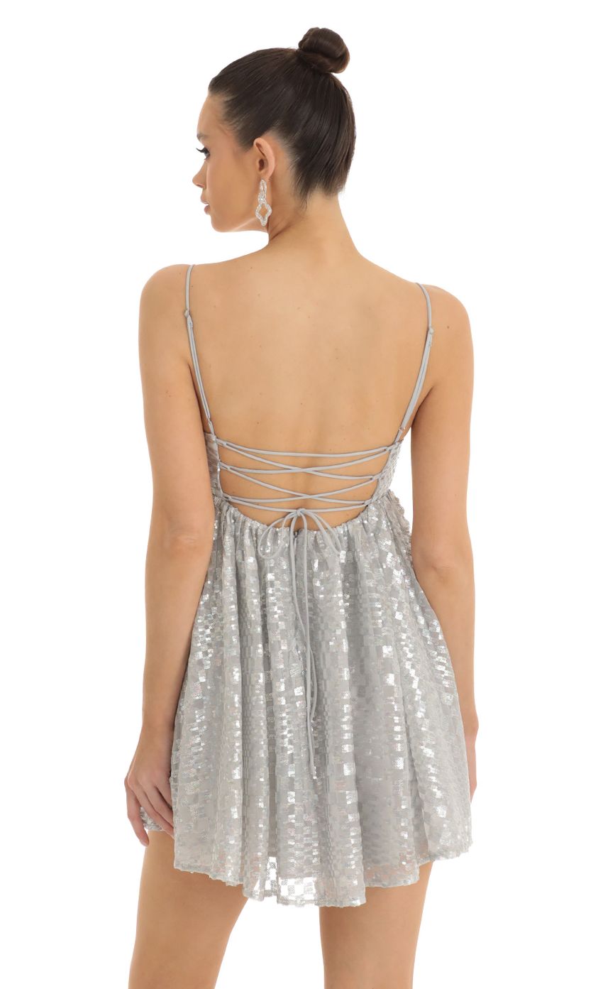 Picture Liora Checkered Sequin Baby Doll Dress in Silver. Source: https://media.lucyinthesky.com/data/Jan23/850xAUTO/ac303971-48a9-40ce-947c-985b3f803bfe.jpg