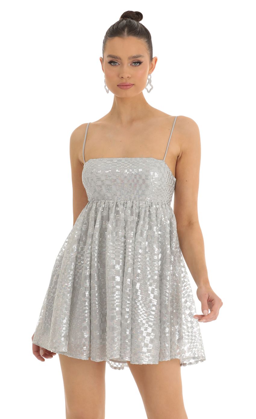 Picture Liora Checkered Sequin Baby Doll Dress in Silver. Source: https://media.lucyinthesky.com/data/Jan23/850xAUTO/ca3b5996-b4ec-4411-aaf1-1e38d429ffdd.jpg