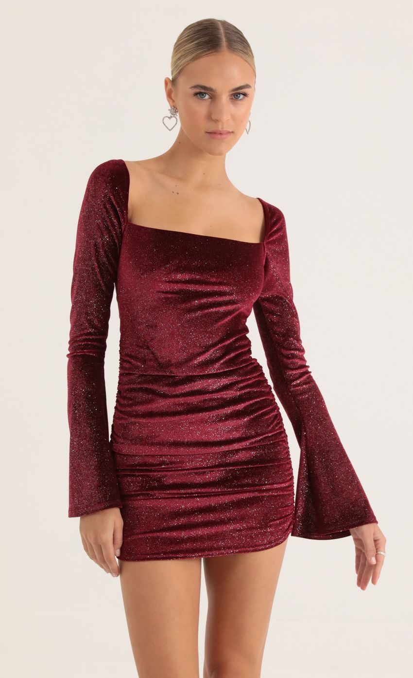 Picture Carmen Glitter Velvet Bell Sleeve Dress in Red. Source: https://media.lucyinthesky.com/data/Jan23/850xAUTO/cee52165-ab9e-4f28-a7a7-dc3c8f6a7d3c.jpg