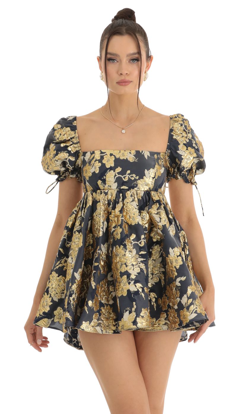 Picture Cheri Gold Floral Jacquard Baby Dolly Dress in Navy. Source: https://media.lucyinthesky.com/data/Jan23/850xAUTO/dd6a65c8-8ebe-4658-b9db-dbe3689ceb9f.jpg