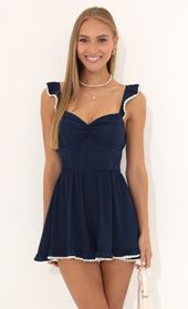 Picture thumb Jane Wooldoby Ruffle Romper in Navy. Source: https://media.lucyinthesky.com/data/Jul22_1/170xAUTO/1V9A0038.JPG