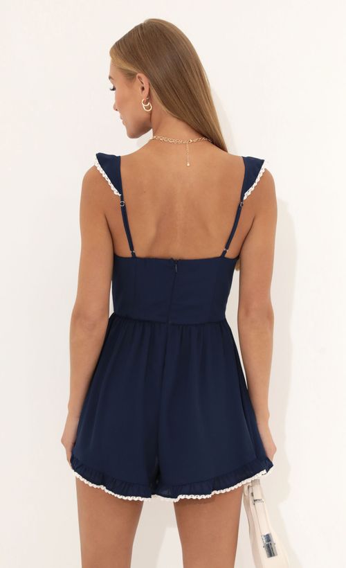Picture Jane Wooldoby Ruffle Romper in Navy. Source: https://media.lucyinthesky.com/data/Jul22_1/500xAUTO/1V9A0115.JPG