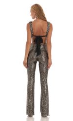 Picture Lupita Gold Sequin Back Bow Tie Jumpsuit in Black. Source: https://media.lucyinthesky.com/data/Jul23/150xAUTO/1b66abaf-1814-4203-a72f-f4aec43b8987.jpg