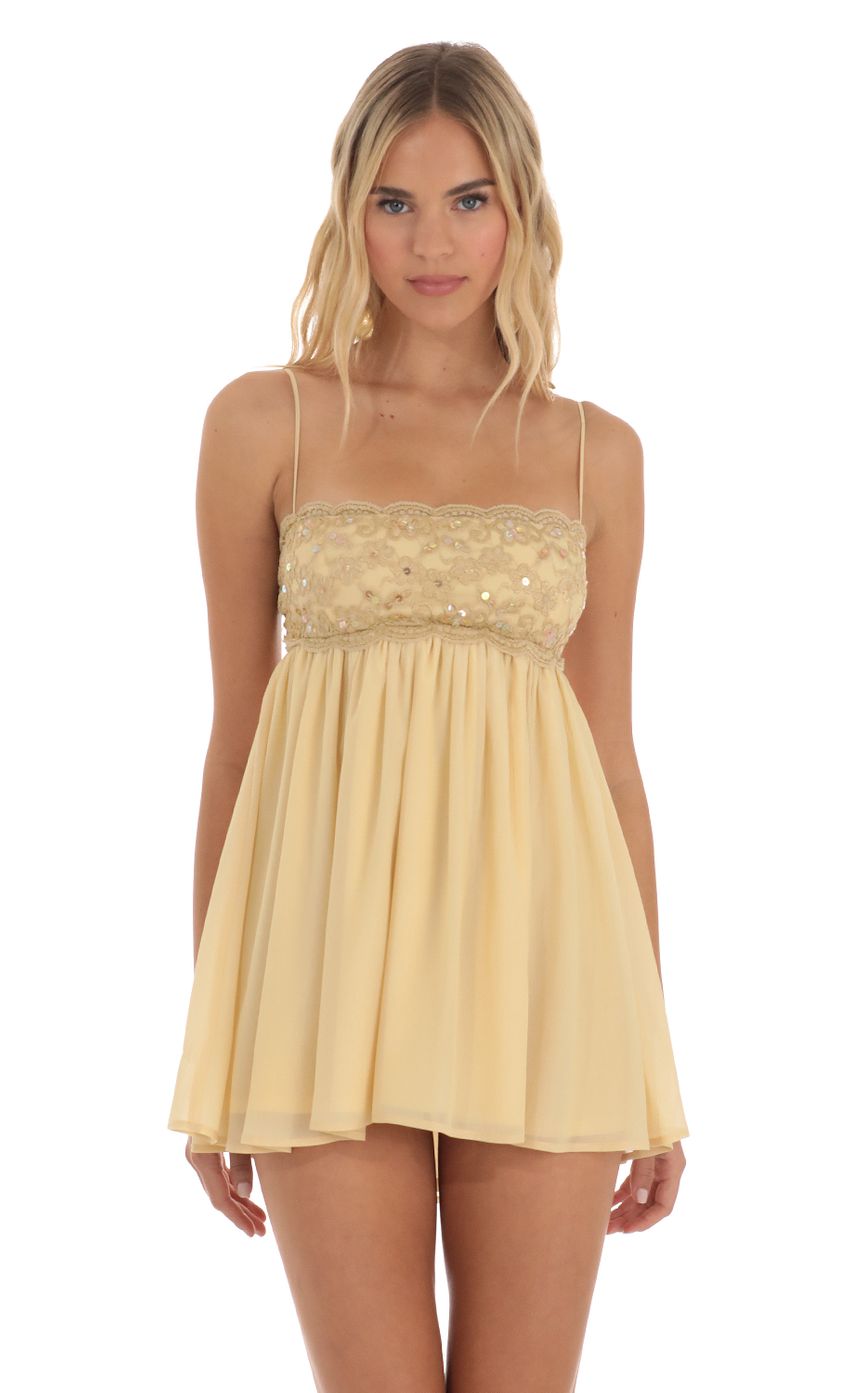Picture Rubina Sequin Lace Baby Doll Dress in Gold. Source: https://media.lucyinthesky.com/data/Jun23/850xAUTO/4257416e-5d1a-44b4-8d68-9775a1994f86.jpg