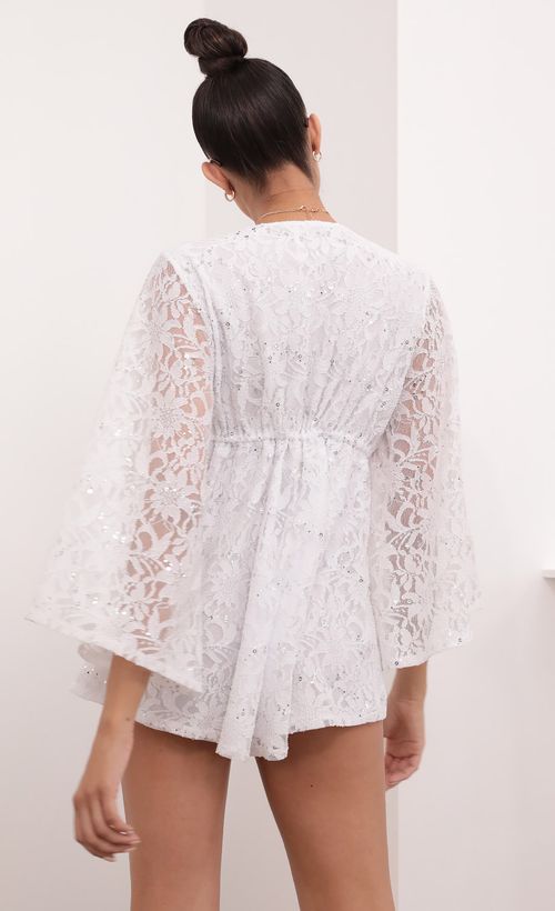 Picture Kadee Bell Sleeve Romper in White Sequined Lace. Source: https://media.lucyinthesky.com/data/Mar21_2/500xAUTO/1V9A5617.JPG