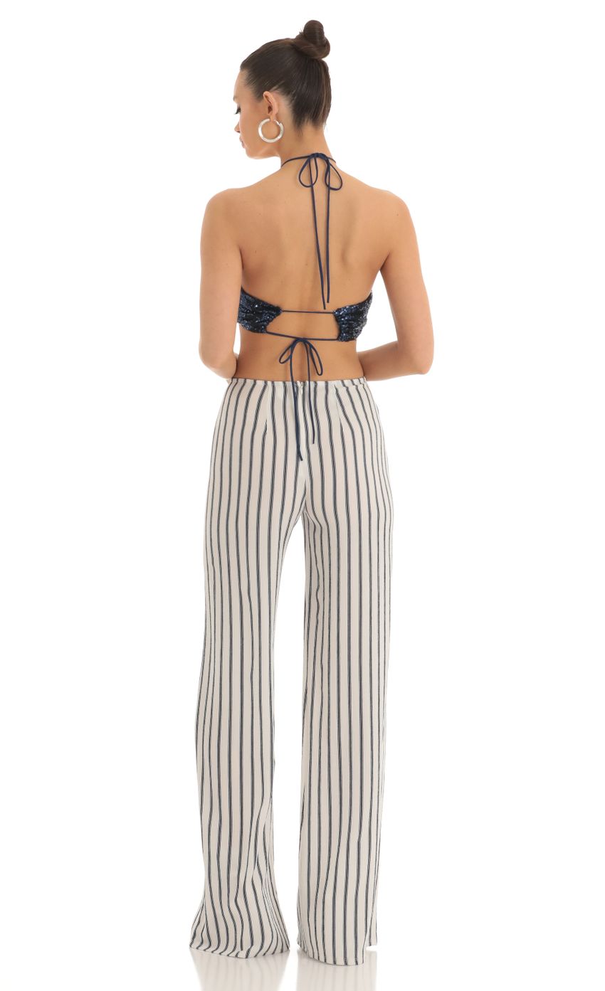 Picture Renae Sequin Halter Striped Jumpsuit in White and Navy. Source: https://media.lucyinthesky.com/data/Mar23/850xAUTO/7765bdaa-16db-442d-a980-22988a828891.jpg