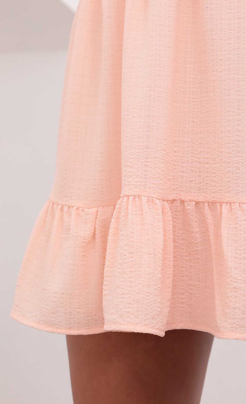 Picture Alanna V-Neck Ruffle Dress in Pastel Salmon. Source: https://media.lucyinthesky.com/data/May21_1/850xAUTO/1V9A2429.JPG