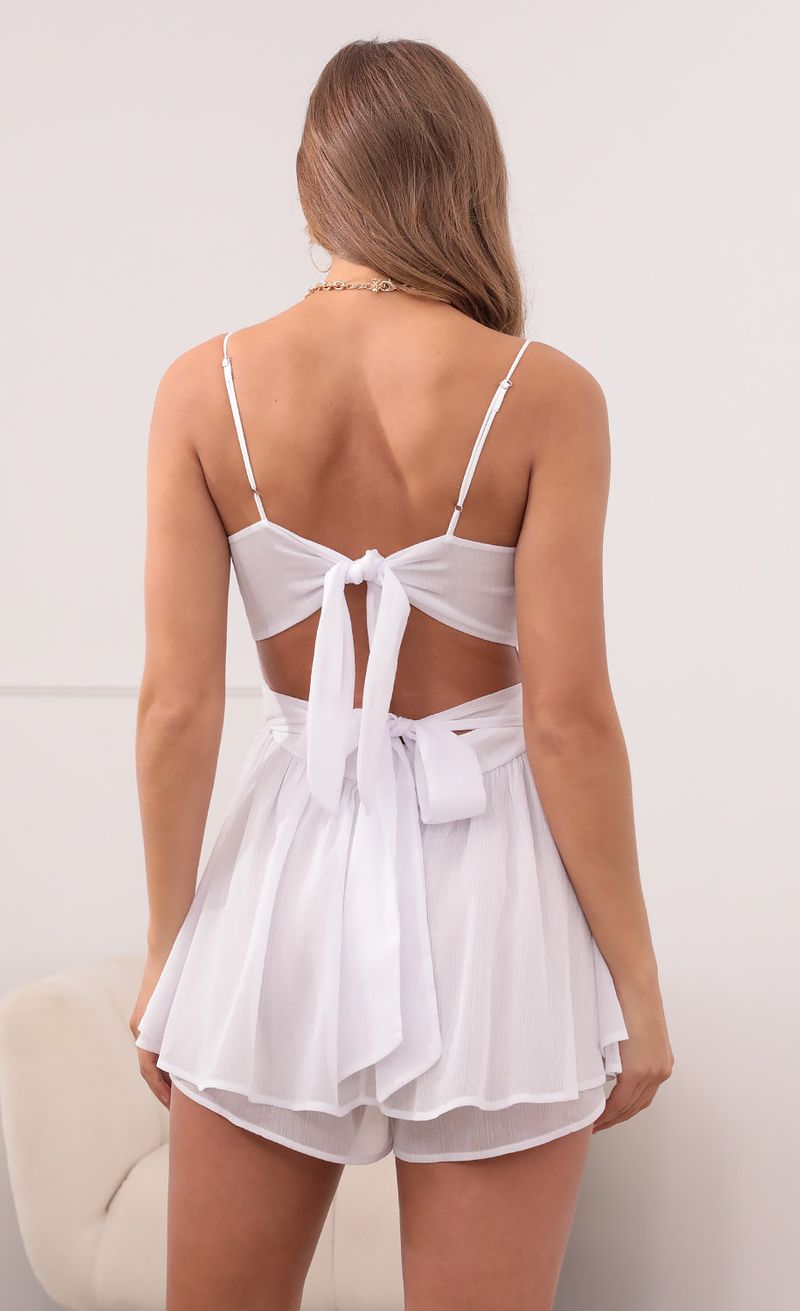 Picture Micaela Double Ruffle Romper in White Shimmer. Source: https://media.lucyinthesky.com/data/May21_2/800xAUTO/1V9A3639.JPG