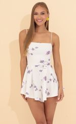 Picture Bella Floral Pleated Romper in Blue. Source: https://media.lucyinthesky.com/data/May22_2/150xAUTO/1V9A7788.JPG