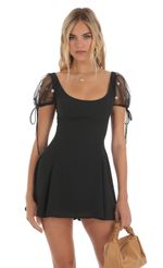 Picture Wannda Sequin Floral Chiffon Puff Sleeve Dress in Black. Source: https://media.lucyinthesky.com/data/May23/150xAUTO/5deb9311-faa5-4c88-8403-e322255c8e51.jpg