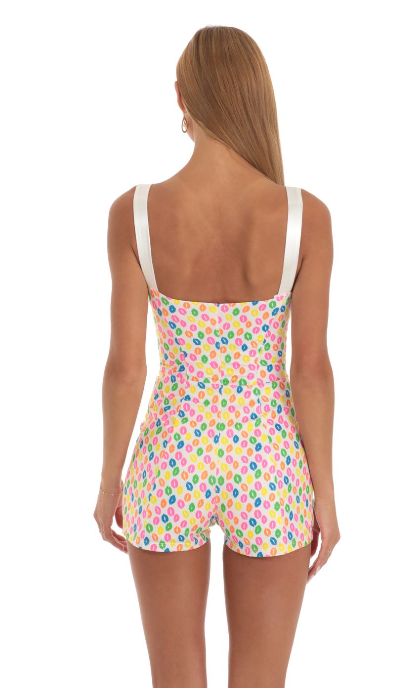 Picture Rada Hook and Eye Romper in Multi Kiss Print. Source: https://media.lucyinthesky.com/data/May23/850xAUTO/36e64c37-23bc-496c-be59-a3bfc3ae7696.jpg