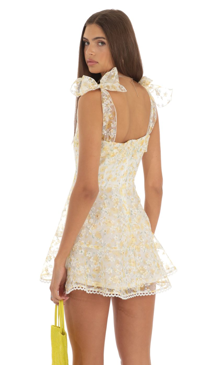 Picture Zev Shimmer Yellow Floral Mini Dress in White. Source: https://media.lucyinthesky.com/data/May23/850xAUTO/3769e22d-940f-4738-aec1-535e175b38cc.jpg