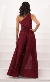 Picture thumb Mary One Shoulder Jumpsuit in Burgundy Shimmer. Source: https://media.lucyinthesky.com/data/Oct20_1/170xAUTO/1V9A21751.JPG