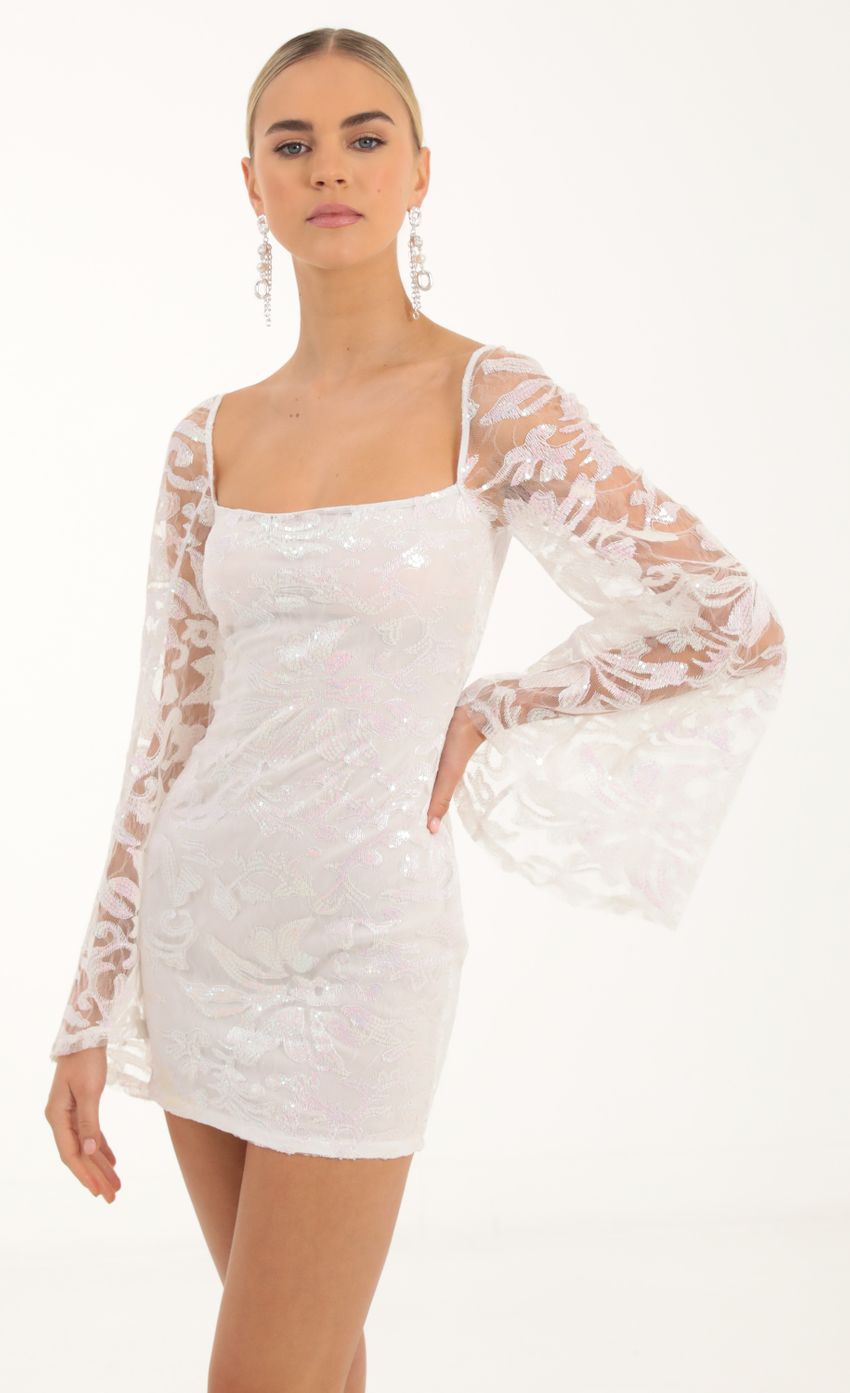 Picture Elly Tulle Iridescent Sequin Flare Sleeve Dress in White. Source: https://media.lucyinthesky.com/data/Oct22/850xAUTO/62ece87a-4807-4c47-a9e9-4f9069ee0209.jpg