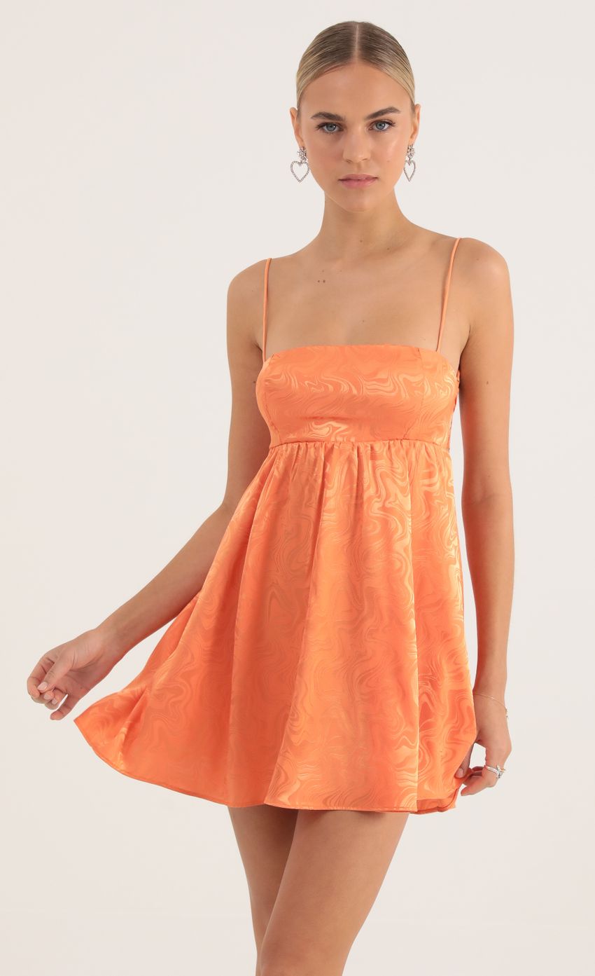 Picture Juno Satin Marble Baby Doll Dress in Orange. Source: https://media.lucyinthesky.com/data/Oct22/850xAUTO/c43a78f5-7c2c-477a-8b49-24d1723a7622.jpg