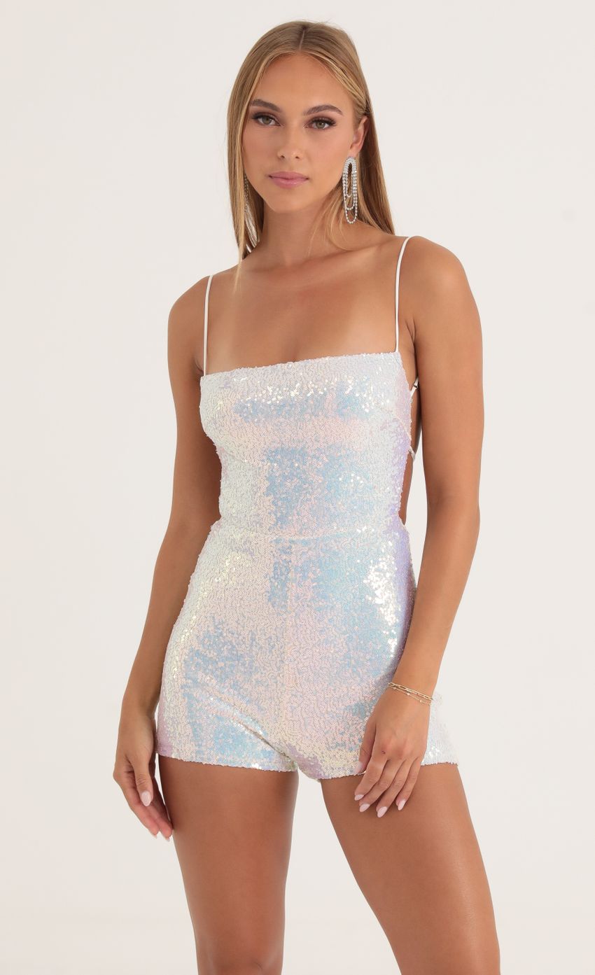 Picture Legacy Iridescent Sequin Open Back Romper in White. Source: https://media.lucyinthesky.com/data/Oct22/850xAUTO/ea2b8621-228c-459b-a5f9-085bb8b407b0.jpg