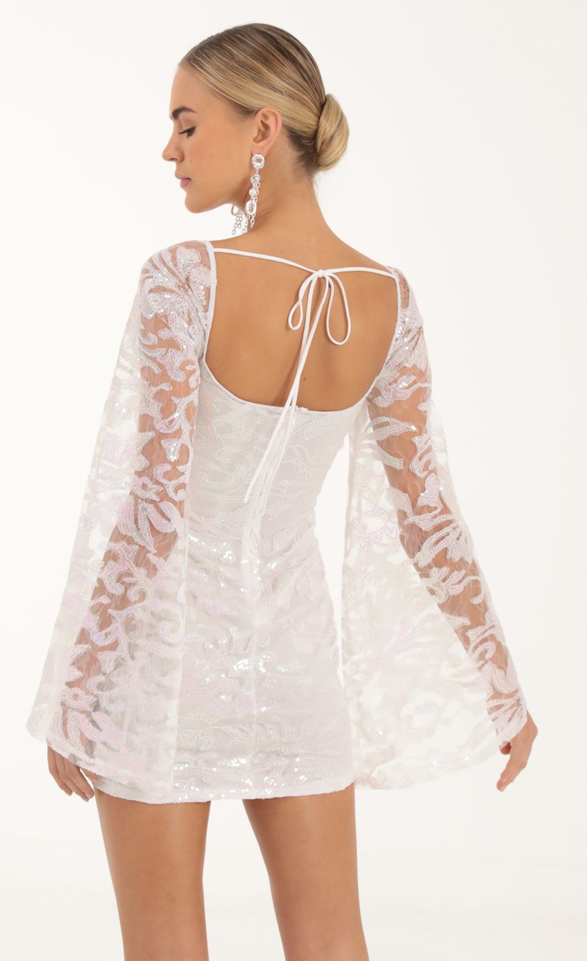 Picture Elly Tulle Iridescent Sequin Flare Sleeve Dress in White. Source: https://media.lucyinthesky.com/data/Oct22/850xAUTO/f74e2663-12e5-4869-aa95-f515c31256c3.jpg