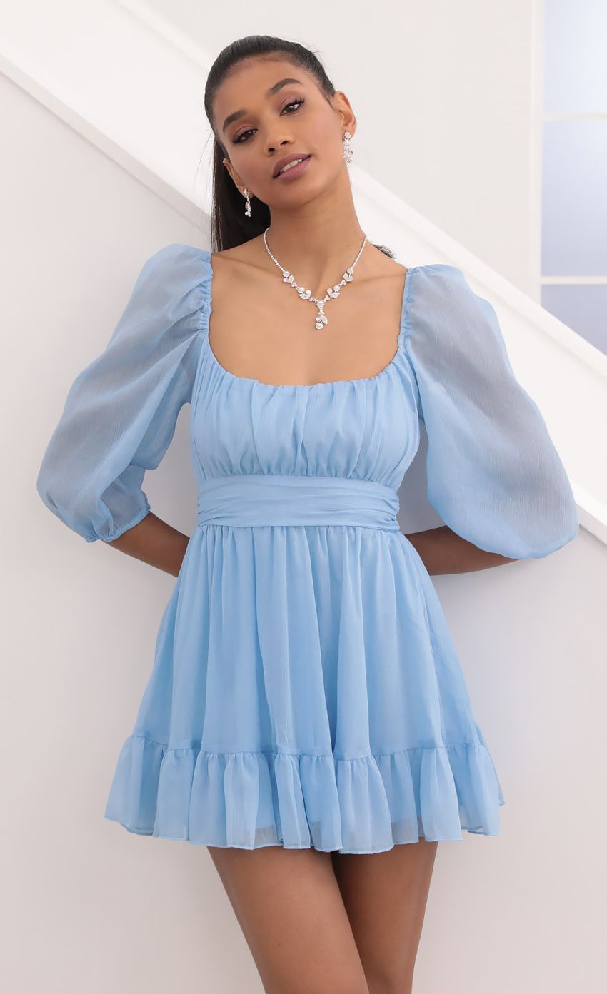 Picture Neia Ruffle Dress in Blue Sparkly Chiffon. Source: https://media.lucyinthesky.com/data/Sep20_2/850xAUTO/781A0252.JPG