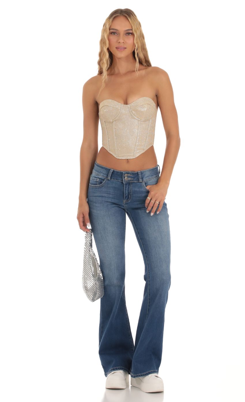 Picture Macy Shimmer Corset Top in Gold. Source: https://media.lucyinthesky.com/data/Sep23/850xAUTO/165a1190-e9a3-4c79-b4ef-ae9e50a06d38.jpg