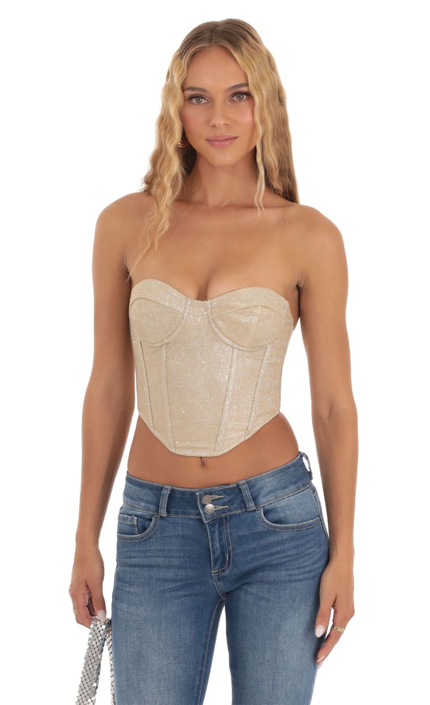 Picture Macy Shimmer Corset Top in Gold. Source: https://media.lucyinthesky.com/data/Sep23/850xAUTO/9c0477ca-2e68-433a-9d7d-82f6c1be8d3b.jpg